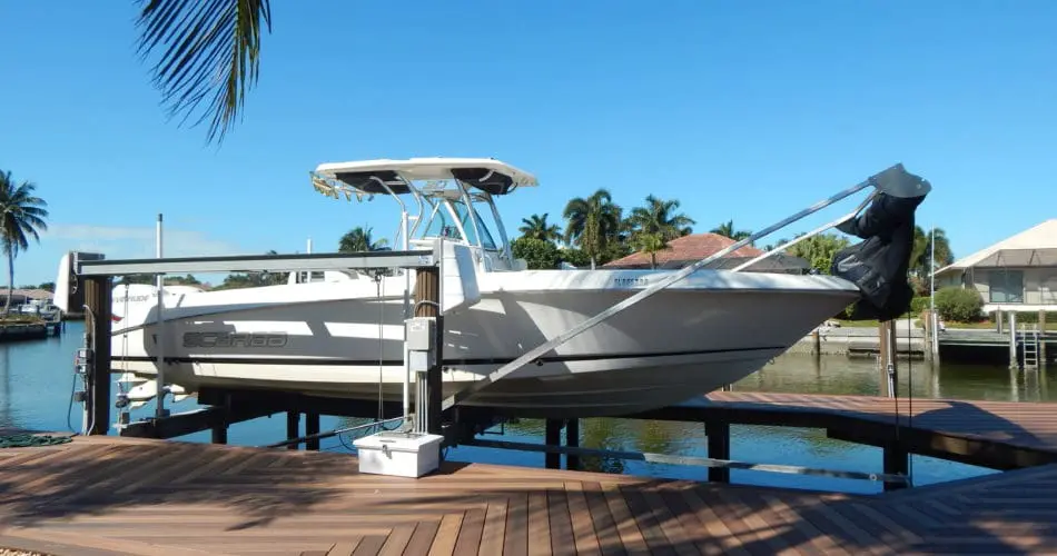 boat lifted on a boat lift next to a dock